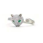 Wholesale leopard head ring with green zircon eyes and clear pavé stones on 18K gold plated copper from JuneJewelry.com – adjustable animal jewelry for bulk orders.