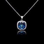 Wholesale cushion crystal necklace with a deep blue Swarovski Elements stone and halo pendant on platinum plated copper from JuneJewelry.com.