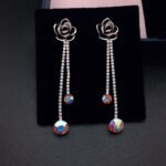 Wholesale rose crystal earrings with blue Swarovski Elements crystals on platinum plated brass by JuneJewelry.com – unique tassel earrings for bulk order.