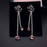 Wholesale rose crystal earrings with blue Swarovski Elements crystals on platinum plated brass by JuneJewelry.com – unique tassel earrings for bulk order.