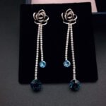 Wholesale rose crystal earrings with blue Swarovski Elements crystals on platinum plated brass by JuneJewelry.com – unique tassel earrings for bulk order.