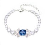 Wholesale blue crystal bracelet with square Swarovski Elements crystal and butterfly accents on platinum plated brass by JuneJewelry.com – luxury bulk jewelry.