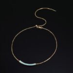 Niche light luxury geometric turquoise jewelry set wholesale displaying a micro-pave turquoise-blue curved bar smile necklace, matching huggie hoop earrings, and an open adjustable ring on junejewelry.com