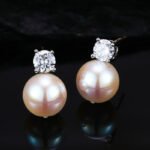 High-end light luxury pearl jewelry set wholesale featuring a brilliant round zircon solitaire pendant necklace and matching pearl stud earrings from junejewelry.com