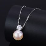 High-end light luxury pearl jewelry set wholesale featuring a brilliant round zircon solitaire pendant necklace and matching pearl stud earrings from junejewelry.com