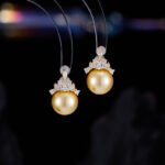 High-end light luxury crown pearl jewelry set wholesale featuring a delicate micro-pave zircon tiara cap pendant necklace and matching pearl stud earrings on junejewelry.com