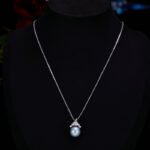 High-end light luxury crown pearl jewelry set wholesale featuring a delicate micro-pave zircon tiara cap pendant necklace and matching pearl stud earrings on junejewelry.com