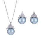 High-end light luxury crown pearl jewelry set wholesale featuring a delicate micro-pave zircon tiara cap pendant necklace and matching pearl stud earrings on junejewelry.com