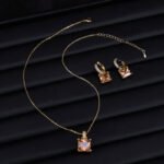 Elegant geometric square crystal jewelry wholesale set featuring micro-pave rhinestone huggie hoop earrings and matching pendant necklace from junejewelry.com