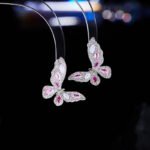 Niche light luxury butterfly zircon jewelry set wholesale featuring an intricate micro-pave crystal butterfly Y-shaped choker necklace with a drop pearl and matching butterfly stud earrings on junejewelry.com