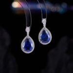 Premium luxury teardrop zircon jewelry set wholesale featuring a solitaire pear-cut pendant necklace, drop earrings, and halo ring on junejewelry.com