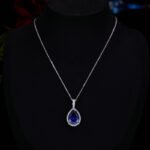 Premium luxury teardrop zircon jewelry set wholesale featuring a solitaire pear-cut pendant necklace, drop earrings, and halo ring on junejewelry.com