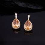 Premium luxury teardrop zircon jewelry set wholesale featuring a solitaire pear-cut pendant necklace, drop earrings, and halo ring on junejewelry.com