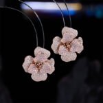 Elegant vintage French style camellia zircon jewelry set wholesale featuring a multi-layered micro-pave crystal flower pendant on an asymmetric pearl chain and matching flower stud earrings on junejewelry.com