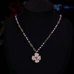 Elegant vintage French style camellia zircon jewelry set wholesale featuring a multi-layered micro-pave crystal flower pendant on an asymmetric pearl chain and matching flower stud earrings on junejewelry.com