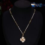 Elegant vintage French style camellia zircon jewelry set wholesale featuring a multi-layered micro-pave crystal flower pendant on an asymmetric pearl chain and matching flower stud earrings on junejewelry.com