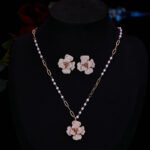 Elegant vintage French style camellia zircon jewelry set wholesale featuring a multi-layered micro-pave crystal flower pendant on an asymmetric pearl chain and matching flower stud earrings on junejewelry.com