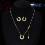 Sparkly horseshoe U shape jewelry set wholesale featuring micro zircon pendant necklace and stud earrings in 18K gold plating from junejewelry.com