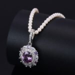 High-end oval zircon pearl jewelry set wholesale featuring a royal crystal cluster pendant on a classic pearl strand and matching statement stud earrings from junejewelry.com