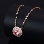 High-end round halo zircon jewelry set wholesale featuring a brilliant solitaire crystal pendant necklace and matching round stud earrings from junejewelry.com