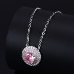 High-end round halo zircon jewelry set wholesale featuring a brilliant solitaire crystal pendant necklace and matching round stud earrings from junejewelry.com