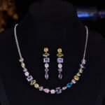 Light luxury colorful crystal resort jewelry set wholesale featuring a fresh multi-geometric cut gemstone collar necklace and matching linear drop earrings from junejewelry.com