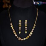 Light luxury colorful crystal resort jewelry set wholesale featuring a fresh multi-geometric cut gemstone collar necklace and matching linear drop earrings from junejewelry.com