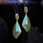 Western heavy-craft geometric conch shell zircon jewelry set wholesale featuring a curved, bi-color micro-pave emerald green and turquoise blue fold pendant necklace and matching drop earrings from junejewelry.com