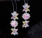 Western style heavy-craft luxury flower zircon jewelry set wholesale featuring an interlocking marquise and oval cut colorful crystal floral collar necklace with matching linear drop earrings from junejewelry.com