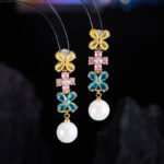Western style light luxury flower zircon jewelry set wholesale featuring a colorful crystal floral tennis choker necklace and matching triple-tier flower pearl drop earrings from junejewelry.com
