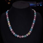 Western style light luxury flower zircon jewelry set wholesale featuring a colorful crystal floral tennis choker necklace and matching triple-tier flower pearl drop earrings from junejewelry.com