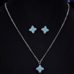 Niche high-end turquoise four leaf clover jewelry set wholesale featuring marquise-cut turquoise resin petals framed by brilliant micro-pave crystals from junejewelry.com