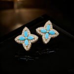 Niche high-end turquoise four leaf clover jewelry set wholesale featuring marquise-cut turquoise resin petals framed by brilliant micro-pave crystals from junejewelry.com