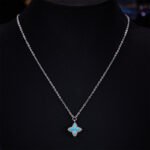 Niche high-end turquoise four leaf clover jewelry set wholesale featuring marquise-cut turquoise resin petals framed by brilliant micro-pave crystals from junejewelry.com