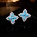 Niche high-end turquoise four leaf clover jewelry set wholesale featuring marquise-cut turquoise resin petals framed by brilliant micro-pave crystals from junejewelry.com