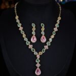 High-end cross-border heavy-craft colorful gemstone jewelry set wholesale featuring a cascading V-shaped multi-colored crystal necklace with a pink teardrop drop and matching long drop earrings from junejewelry.com