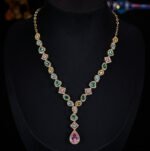 High-end cross-border heavy-craft colorful gemstone jewelry set wholesale featuring a cascading V-shaped multi-colored crystal necklace with a pink teardrop drop and matching long drop earrings from junejewelry.com