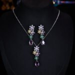Cross-border high-end colorful zircon flower jewelry set wholesale featuring a cascading multi-colored crystal floral cluster pendant necklace with a dark purple teardrop drop and matching long drop earrings from junejewelry.com.