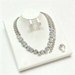 Wholesale square zircon set with emerald-cut clear crystals on real gold plated copper from JuneJewelry.com – luxury bridal jewelry for bulk buyers.