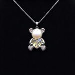 Wholesale Heart Bear Necklace with a crystal heart and pearl on platinum plated brass from JuneJewelry.com.