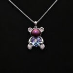 Wholesale Heart Bear Necklace with a crystal heart and pearl on platinum plated brass from JuneJewelry.com.