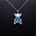 Wholesale Heart Bear Necklace with a crystal heart and pearl on platinum plated brass from JuneJewelry.com.