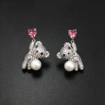 Wholesale Swarovski Bear Earrings featuring pink heart crystals on platinum plated brass from JuneJewelry.com.