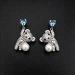 Wholesale Swarovski Bear Earrings featuring pink heart crystals on platinum plated brass from JuneJewelry.com.