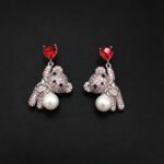 Wholesale Swarovski Bear Earrings featuring pink heart crystals on platinum plated brass from JuneJewelry.com.