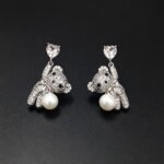 Wholesale Swarovski Bear Earrings featuring pink heart crystals on platinum plated brass from JuneJewelry.com.