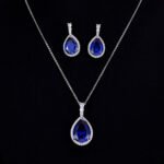 Premium luxury teardrop zircon jewelry set wholesale featuring a solitaire pear-cut pendant necklace, drop earrings, and halo ring on junejewelry.com