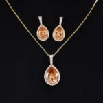 Premium luxury teardrop zircon jewelry set wholesale featuring a solitaire pear-cut pendant necklace, drop earrings, and halo ring on junejewelry.com