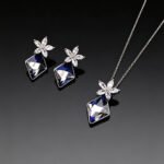 Wholesale crystal jewelry set made of white gold plated copper with floral details and geometric Swarovski element crystals from JuneJewelry.com.