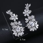 Wholesale floral zircon earrings with clear cubic zirconia petals on platinum plated brass from JuneJewelry.com – bridal chandelier drop earrings for bulk purchase.